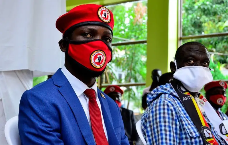 FILE PHOTO: Ugandan musician turned politician, Robert Kyagulanyi also known as Bobi Wine and Uganda's four time Presidential candidate Kizza Besigye attend a joint news conference in Kampala FILE PHOTO: Ugandan musician turned politician, Robert Kyagulanyi, also known as Bobi Wine, and Uganda's four time Presidential candidate Kizza Besigye attend a joint news conference over the government handling of the coronavirus disease (COVID-19) pandemic and a possible alliance against President Yoweri Museveni in the upcoming elections, in Wakiso district, in Kampala, Uganda June 15, 2020. REUTERS/Abubaker Lubowa/File Photo
