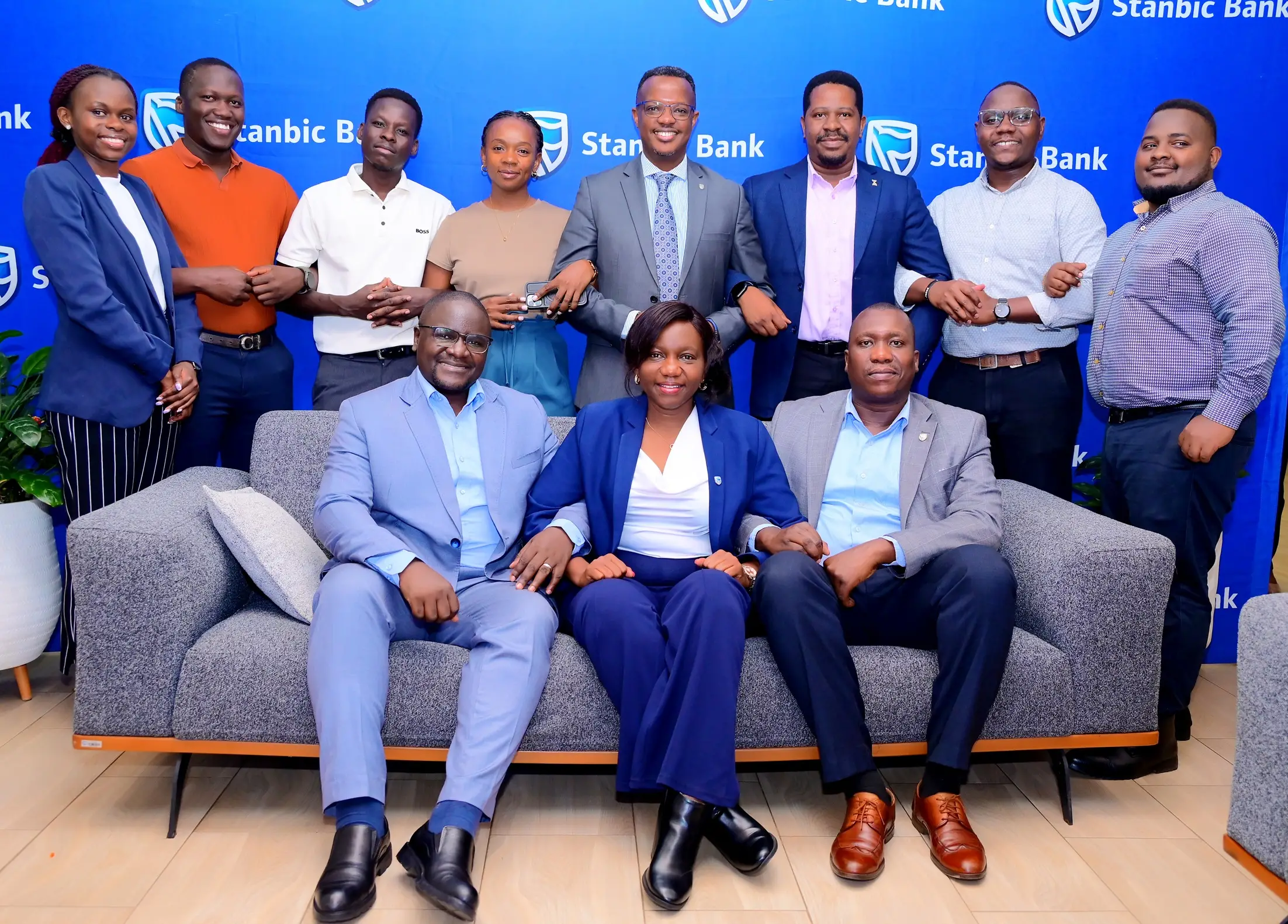 Stanbic Bank Uganda staff members led Sam Bulenzi (R) Stanbic Bank Head of Coverage pose for a group photo during the launch in Kampala Stanbic Bank Uganda staff members led Sam Bulenzi (R) Stanbic Bank Head of Coverage pose for a group photo during the launch in Kampala